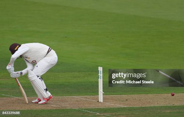 Rikki Clarke of Surrey is bowled by Fidel Edwards of Hampshire during day two of the Specsavers County Championship Division One match between...