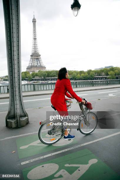 Woman rides his bicycle past the Eiffel tower on a bicycle track on September 6, 2017 in Paris, France. Mayor of Paris, Anne Hidalgo launched the...