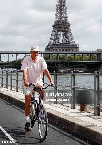 Man rides his bicycle on the newly created bicycle track along the Seine River near the Eiffel Tower on September 6, 2017 in Paris, France. Mayor of...