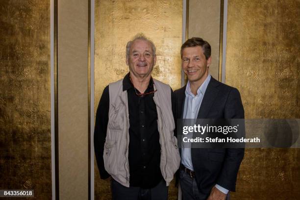 Bill Murray and Frank Briegmann pose for a photo during Universal Inside 2017 organized by Universal Music Group at Mercedes-Benz Arena on September...