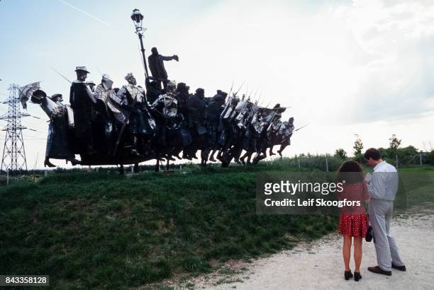 View of a couple as they view a statue in a park, Budapest, Hungary, 1996. After the fall of the Communist government, propaganda statues were moved...