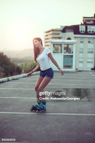 cute sensual female rollerblading on parking area - hot body girls stock pictures, royalty-free photos & images