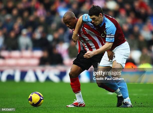 Gareth Barry of Aston Villa battles for the ball with El-Hadji Diouf of Sunderland during the Barclays Premier League match between Sunderland and...