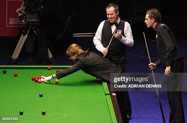 England's Mark Selby and Scotland's John Higgins watch as Referee Michaela Tabb looks for a touching ball during the Masters Snooker semi-final match...