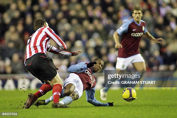 Sunderland's Dean Whitehead is tackled by Aston Villa's Ashley Young, for which he was sent-off, during their FA Premier League football match, on...