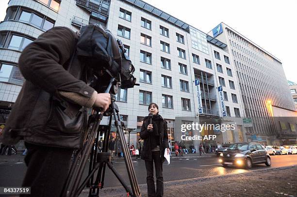 Cameraman and a journalist work on January 17, 2009 in front of Brussels' Sint-Jan / Saint-Jean hospital where Belgium's Queen Fabiola was...