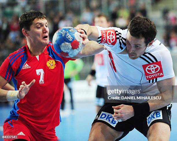 Dmitry Kovalev from Russia vies against Jens Tiedtke from Germany during the Men's World Handball Championship "Croatia 2009" Group C match in...