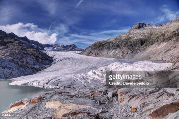 the rhone glacier partially covered with anti-melting white thermal cover - rhone stock-fotos und bilder