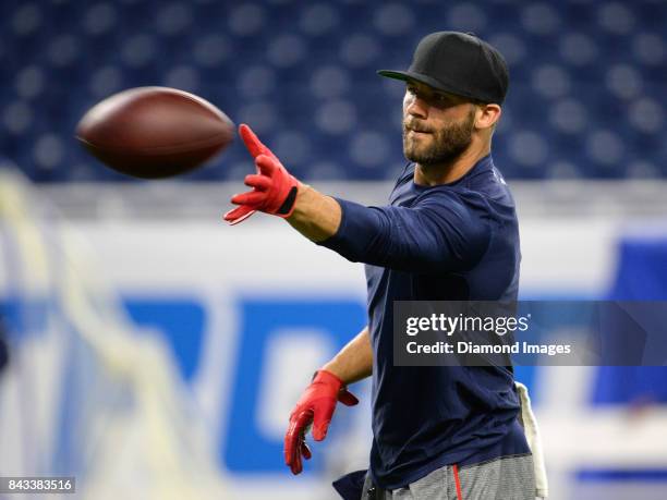 Wide receiver Julian Edelman of the New England Patriots catches a pass as he warms up on the field prior to a preseason game on August 25, 2017...