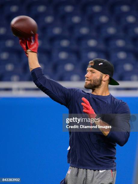 Wide receiver Julian Edelman of the New England Patriots throws a pass as he warms up on the field prior to a preseason game on August 25, 2017...