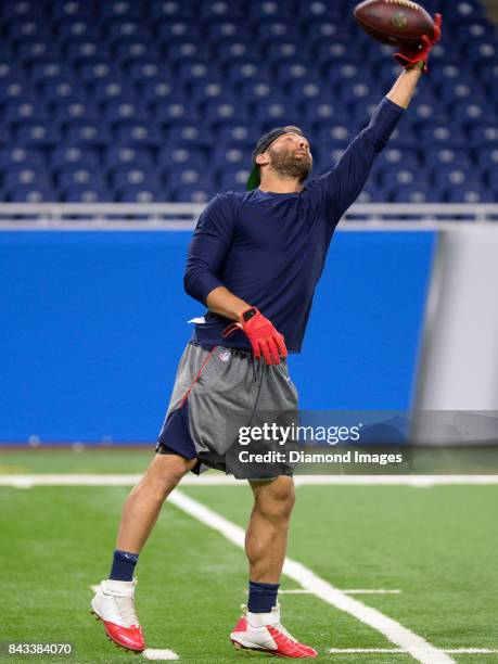 Wide receiver Julian Edelman of the New England Patriots catches a pass as he warms up on the field prior to a preseason game on August 25, 2017...