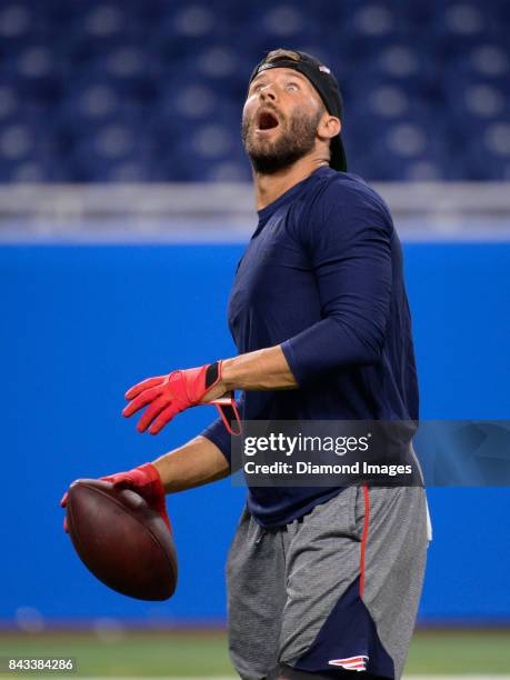 Wide receiver Julian Edelman of the New England Patriots reacts to the lights as he warms up on the field prior to a preseason game on August 25,...