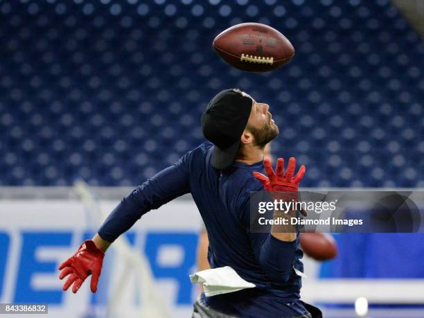 Wide receiver Julian Edelman of the New England Patriots attempts to catch a pass as he warms up on the field prior to a preseason game on August 25,...