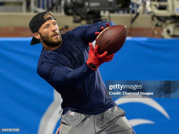 Wide receiver Julian Edelman of the New England Patriots catches a pass as he warms up on the field prior to a preseason game on August 25, 2017...