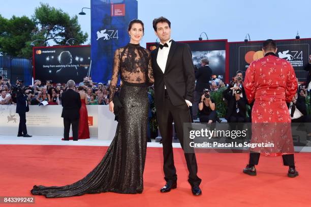 Gloria Bellicchi and Giampaolo Morelli walk the red carpet ahead of the 'Ammore E Malavita' screening during the 74th Venice Film Festival at Sala...