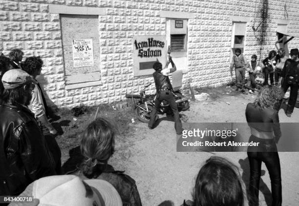 Man swings a sledgehammer at a Japanese motorcycle during a 'Wap-A-Jap" fundraiser behind the Iron Horse Saloon in Daytona Beach, Florida, during the...