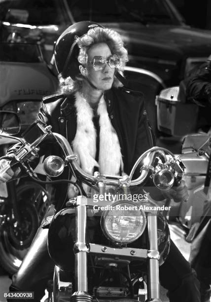 Woman rides her customized motorcycle in Daytona Beach, Florida, during the city's 1983 Bike Week. The annual motorcycle event and rally has...