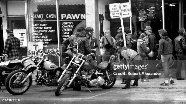 Motorcycle enthusiasts admire customized motorcycles in Daytona Beach, Florida, during the city's 1983 Bike Week. The annual motorcycle event and...