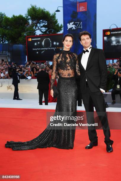 Gloria Bellicchi and Giampaolo Morelli walk the red carpet ahead of the 'Ammore E Malavita' screening during the 74th Venice Film Festival at Sala...