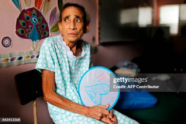 Andrea Rivera sits at an emergency center as Hurricane Irma approaches Puerto Rico in Fajardo, on September 6, 2017. Irma is expected to reach the...