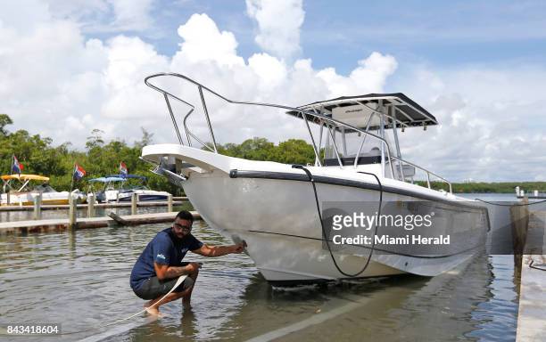 Haulover Marine Center employee Rayden Marquez pulls out one of the many boats from the Haulover Marine Center on Wednesday, Sept. 6, 2017 in Miami...
