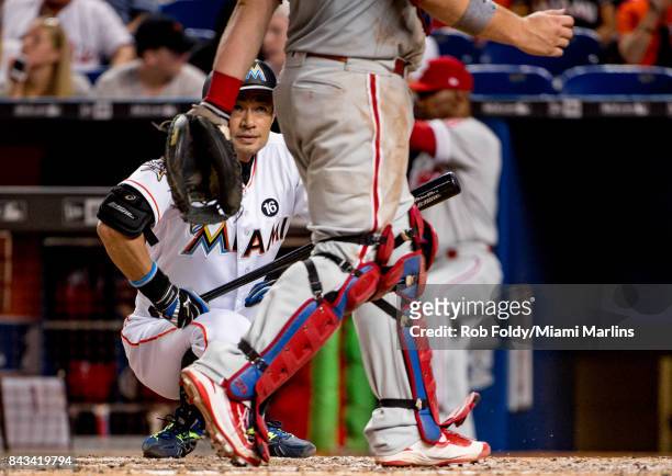 Ichiro Suzuki of the Miami Marlins eyes catcher Cameron Rupp of the Philadelphia Phillies before an at bat during the game at Marlins Park on August...