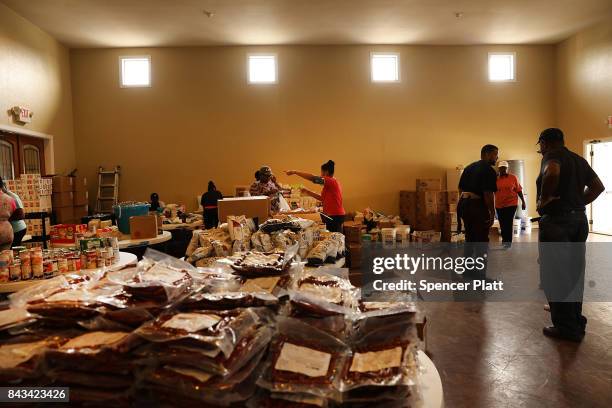 Food is piled on tables at a church that is now a relief center for flood victims in Orange as Texas slowly moves toward recovery from the...