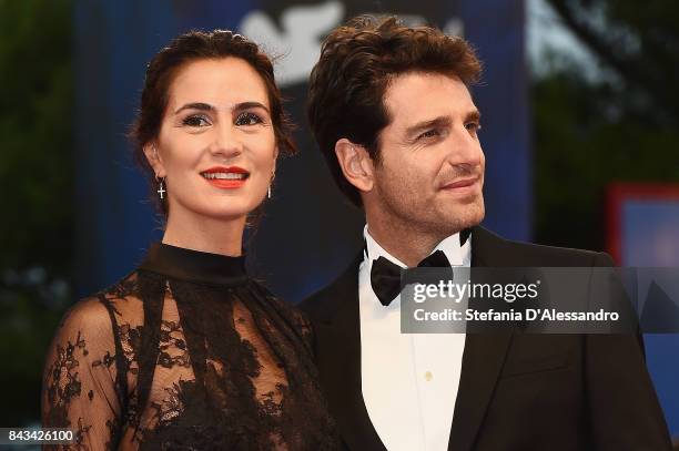 Gloria Bellicchi and Giampaolo Morelli walk the red carpet ahead of the 'Ammore E Malavita' screening during the 74th Venice Film Festival at Sala...