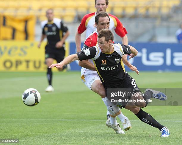 Shane Smeltz of the Phoenix gets tackled by Michael Valkanis of Adelaide during the round 20 A-League match between the Wellington Phoenix and...