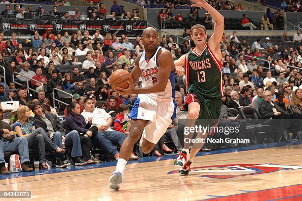 Mardy Collins of the Los Angeles Clippers drives past Luke Ridnour of the Milwaukee Bucks at Staples Center on January 17, 2009 in Los Angeles,...