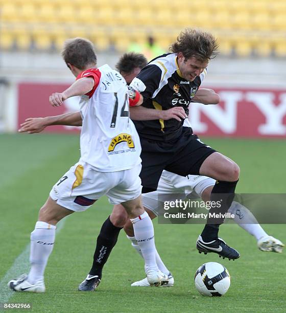 Jon McKain of the Phoenix gets tackled by Scott Jamieson of Adelaide during the round 20 A-League match between the Wellington Phoenix and Adelaide...