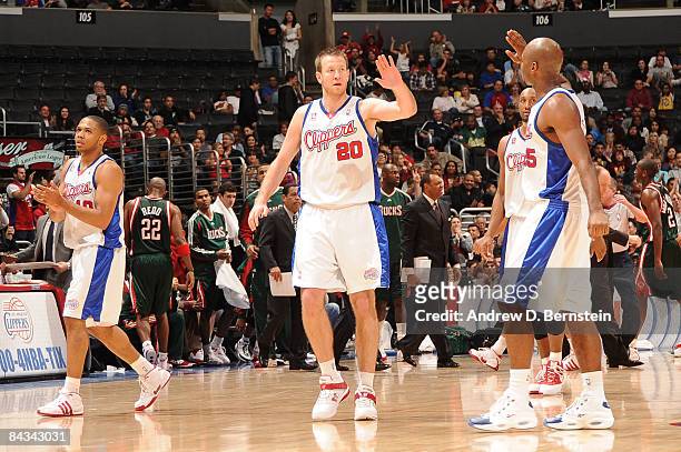 Steve Novak and Mardy Collins of the Los Angeles Clippers slap hands as they walk off the court following their team's victory over the Milwaukee...