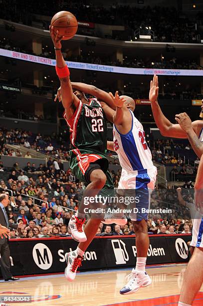 Michael Redd of the Milwaukee Bucks is fouled by Mardy Collins of the Los Angeles Clippers on his way to the basket during their game at Staples...