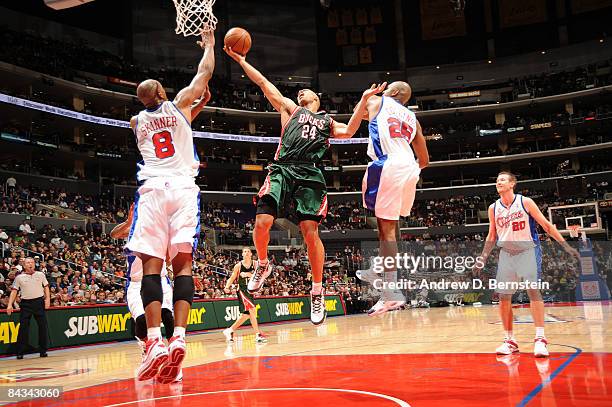 Richard Jefferson of the Milwaukee Bucks goes up for a shot between Brian Skinner and Mardy Collins of the Los Angeles Clippers at Staples Center on...