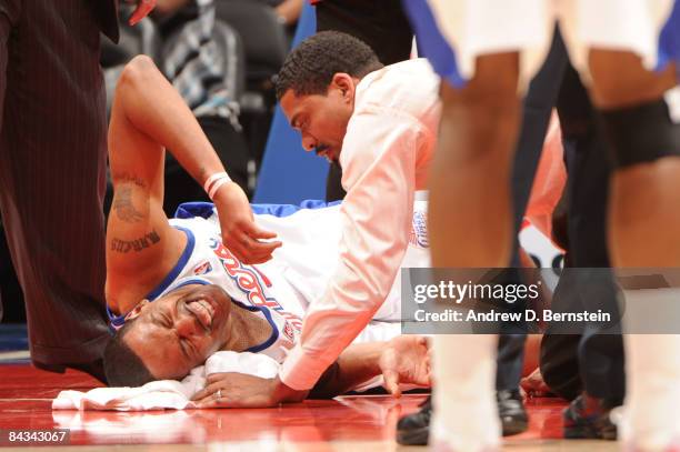 Marcus Camby of the Los Angeles Clippers goes down with a right ankle injury during a game against the Milwaukee Bucks at Staples Center on January...