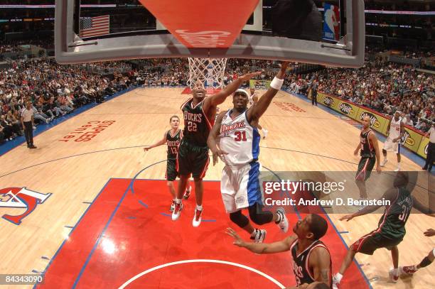 Ricky Davis of the Los Angeles Clippers goes up for a shot against Michael Redd of the Milwaukee Bucks at Staples Center on January 17, 2009 in Los...