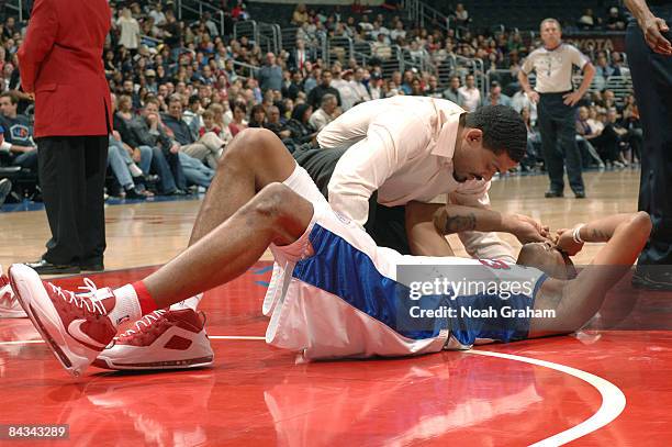 Marcus Camby of the Los Angeles Clippers goes down after injuring his ankle during a game against the Milwaukee Bucks at Staples Center on January...