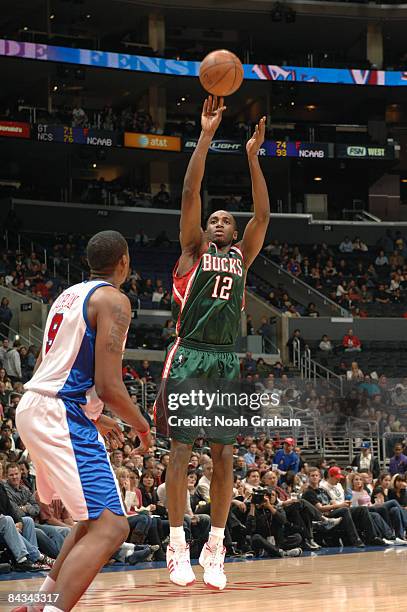 Luc Mbah a Moute of the Milwaukee Bucks shoots while DeAndre Jordan of the Los Angeles Clippers looks on during their game at Staples Center on...