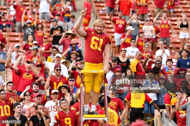 Jake Olson, who is blind, directs the band after playing in his first NCAA Football game between the Western Michigan Broncos and the USC Trojans on...