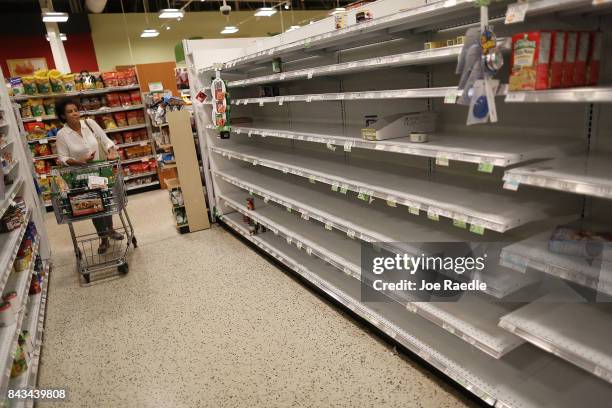 Bare shelves are seen after the supply of bottled water was emptied at a grocery store by people preparing for Hurricane Irma on September 6, 2017 in...