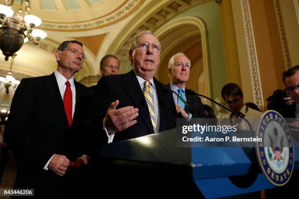 Senate Majority Leader Mitch McConnell , accompanied by Sen. John Barrasso , Sen. John Thune and Sen. John Cornyn , speaks with reporters following...