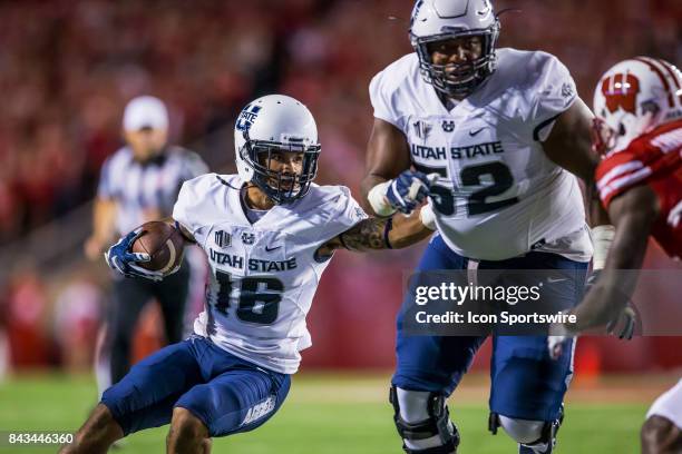 Utah State Aggies wide receiver Jordan Nathan tries to direct Utah State Aggies offensive lineman Sean Taylor to gain more yards durning an college...