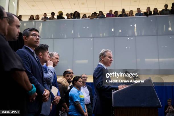 Surrounded by DACA recipients and immigration activists, New York Attorney General Eric Schneiderman speaks during a press conference to announce the...