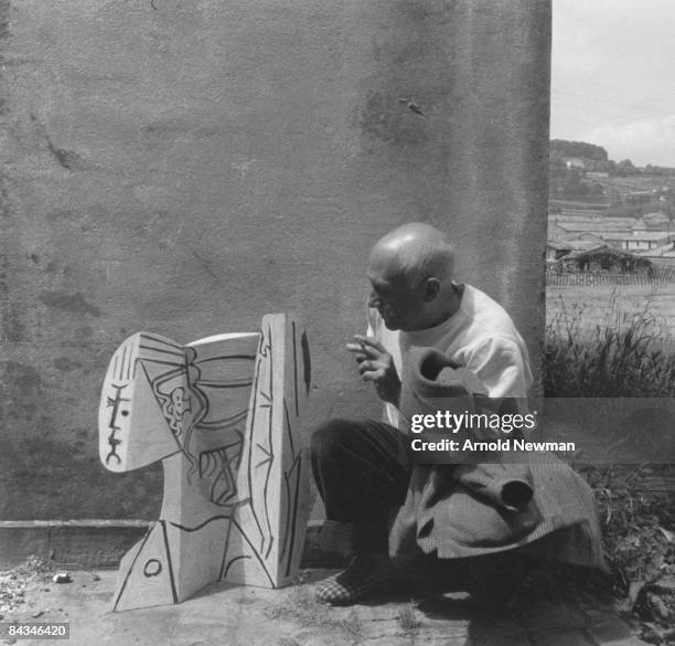 Portrait of Spanish artist Pablo Picasso with a sheet metal sculpture of his muse Sylvette David, aka Lydia Corbett, June 2, 1954 in Vallauris,...