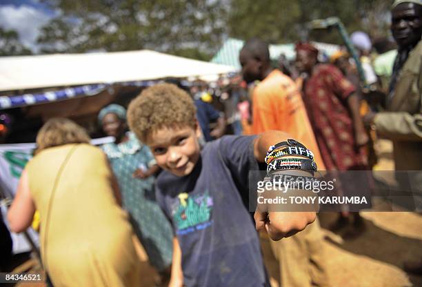 Young US tourist shows his 'Obama' bracelet at Nyang'oma in Kogelo, on January 18, 2009 during festivities by villagers to celebrate the anticipated...