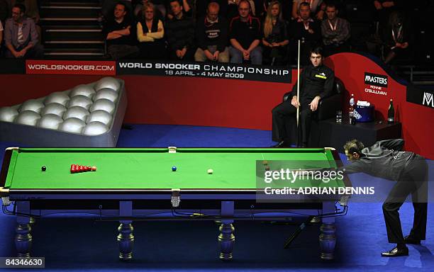 Ronnie O'Sullivan of England looks on from his seat as Mark Selby of England breaks off during the Masters Snooker final at Wembley Conference Centre...