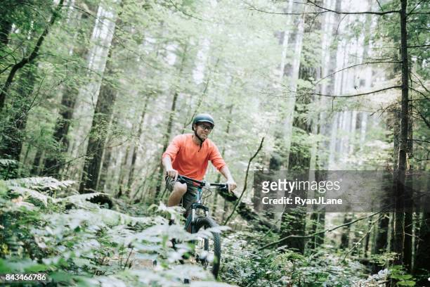 mature man mountain biking in forest - trail ride stock pictures, royalty-free photos & images