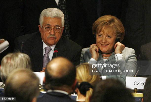 Palestinian Authority President Mahmud Abbas and German Chancellor Angela Merkel talk to the media during a press conference at the end of an...