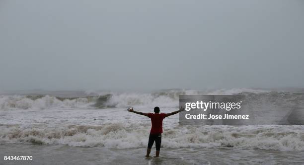 Alexis Ramos stands in the ocean at Luquillo Beach prior to the passing of Hurricane Irma on September 6, 2017 in San Juan, Puerto Rico. The category...