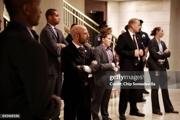 Police and security agents wait outside the Capitol Visitors Center Auditorium as members of the Trump Administrations national security and defense...